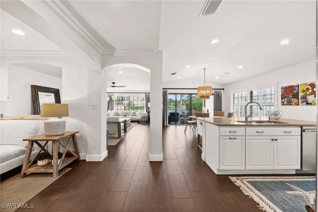 kitchen featuring dark wood-type flooring, sink, ceiling fan, decorative light fixtures, and white cabinetry