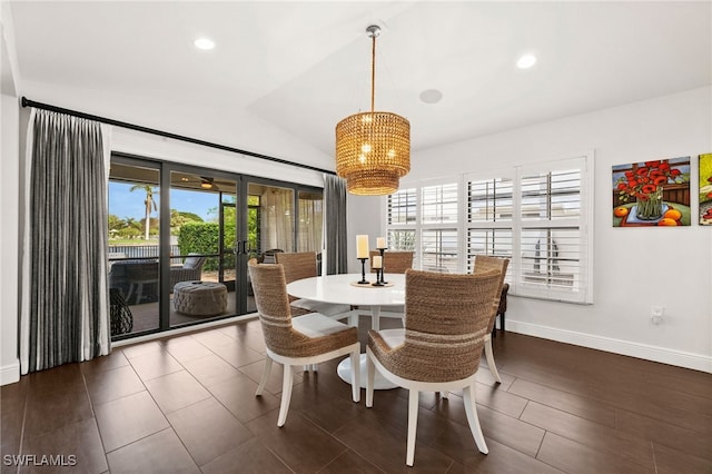 dining area with french doors, an inviting chandelier, dark hardwood / wood-style floors, and vaulted ceiling