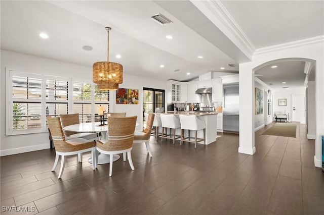 5908 Via Lugano, Naples, FL 34108 - dining space featuring a chandelier, arched walkways, baseboards, crown molding, and recessed lighting