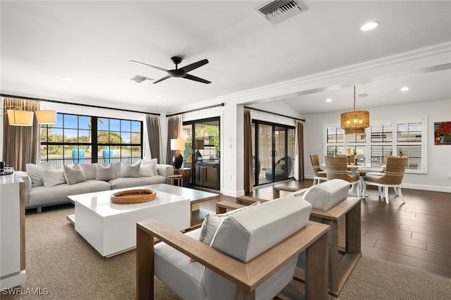 living room with hardwood / wood-style flooring, ceiling fan, and ornamental molding