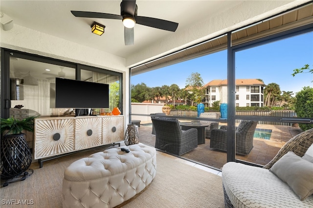 sunroom / solarium featuring ceiling fan