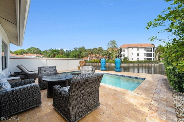 5908 Via Lugano, Naples, FL 34108 - view of swimming pool featuring a patio area, a fenced backyard, and an outdoor living space with a fire pit