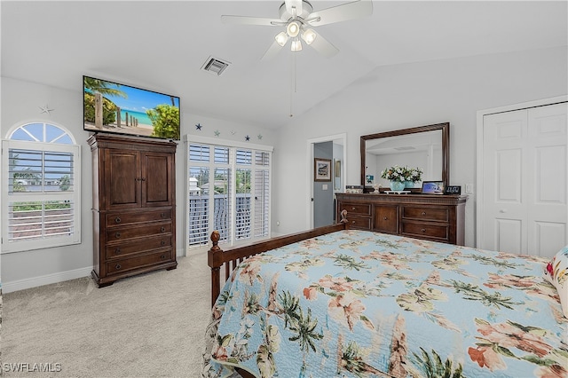 carpeted bedroom with a closet, ceiling fan, and lofted ceiling