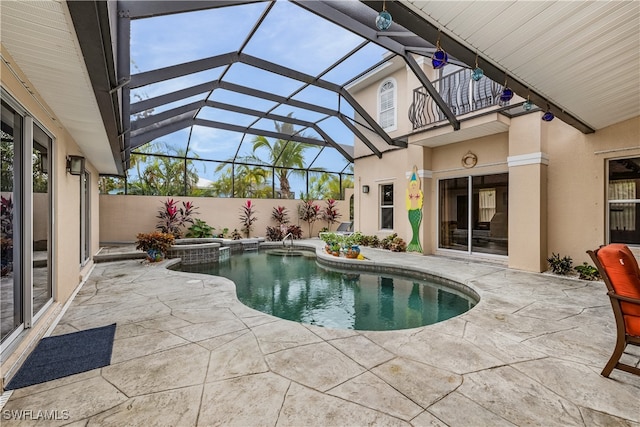 view of swimming pool with a lanai, a patio, and an in ground hot tub