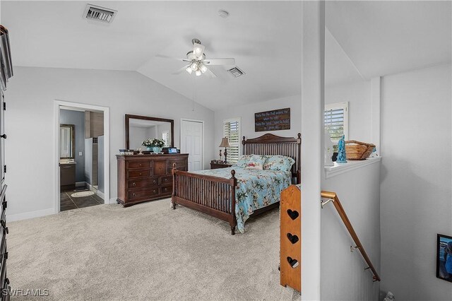 carpeted bedroom with ceiling fan, ensuite bathroom, and lofted ceiling