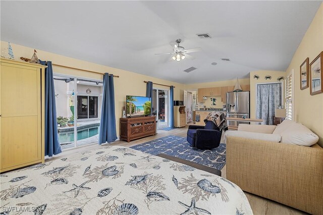 living room featuring wood-type flooring, vaulted ceiling, and ceiling fan