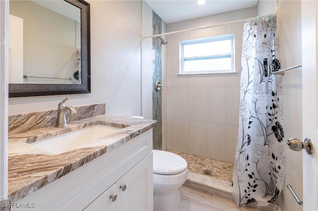 bathroom featuring hardwood / wood-style flooring, a shower with curtain, toilet, and vanity