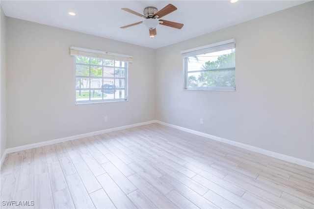 unfurnished room featuring light hardwood / wood-style floors and a wealth of natural light