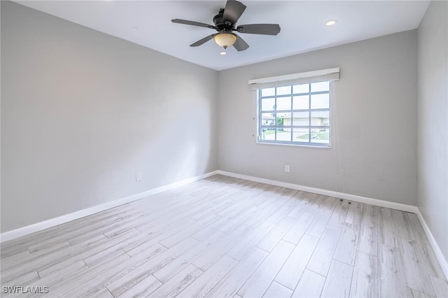 empty room featuring ceiling fan and light hardwood / wood-style flooring