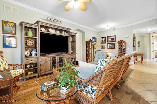 living room featuring crown molding, ceiling fan, and light hardwood / wood-style floors