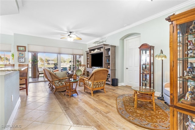 living room featuring ornamental molding, ceiling fan, and light hardwood / wood-style floors