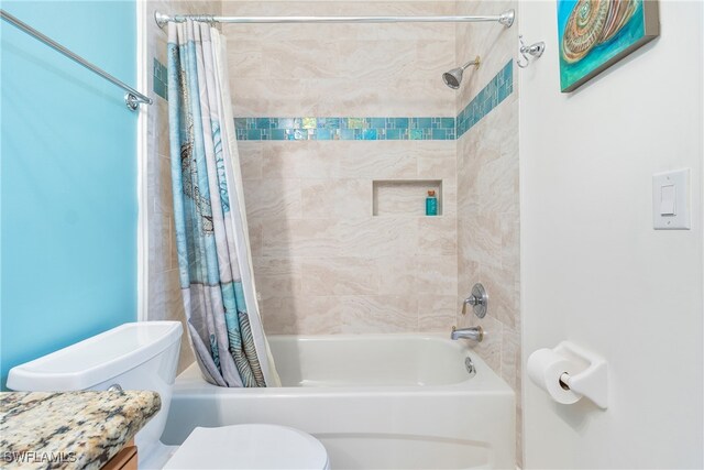 bathroom with shower / tub combo with curtain and toilet