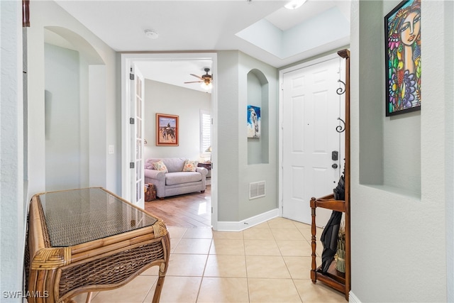 tiled entrance foyer with ceiling fan