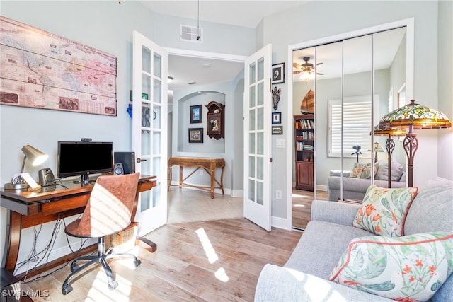 office area with french doors, ceiling fan, and light hardwood / wood-style floors