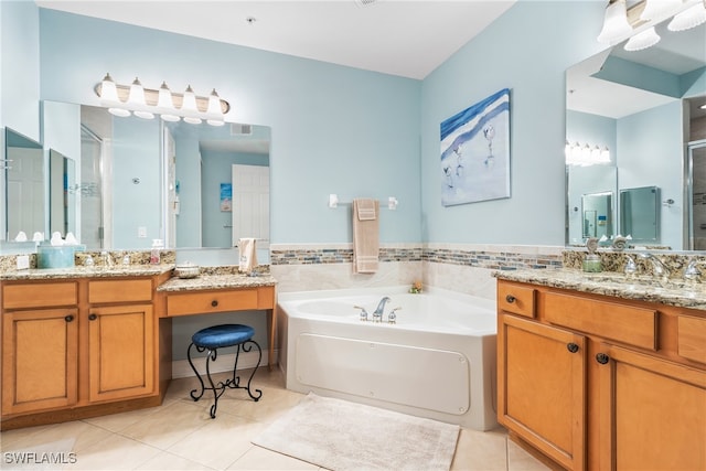 bathroom with vanity, tile patterned flooring, and a tub