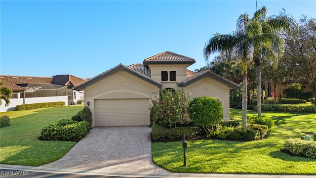 12656 Grandezza Cir, Estero, FL 33928 - mediterranean / spanish house featuring an attached garage, stucco siding, driveway, a front yard, and a tile roof
