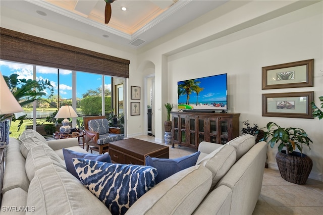 tiled living room featuring ceiling fan and ornamental molding