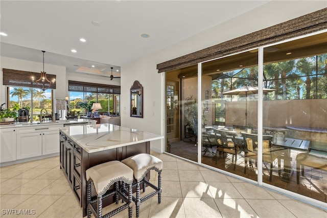 12656 Grandezza Cir, Estero, FL 33928 - dining area with light tile patterned flooring, recessed lighting, and a chandelier