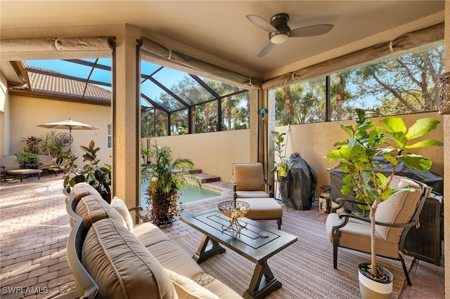 sunroom featuring ceiling fan and lofted ceiling