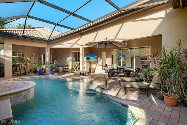 view of swimming pool featuring a patio and a lanai