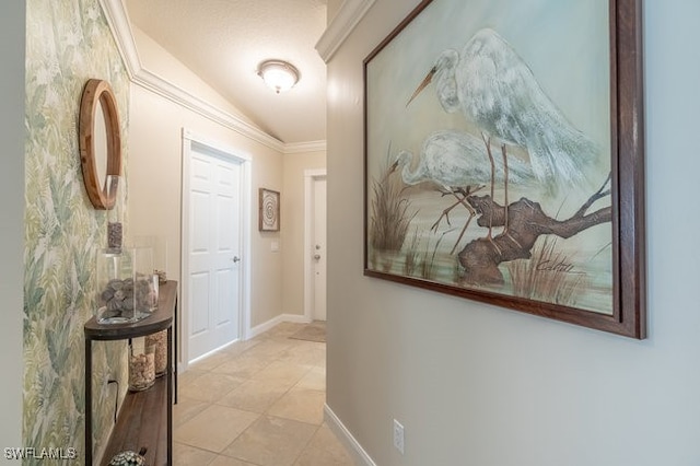 hallway featuring light tile patterned flooring, lofted ceiling, and crown molding