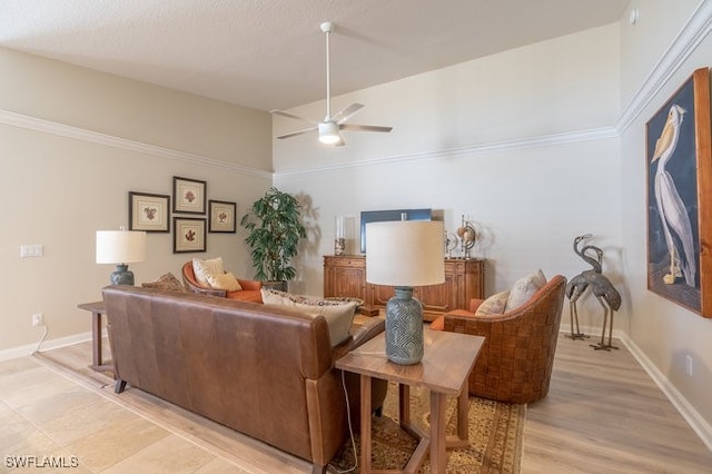 living room with light hardwood / wood-style flooring, ceiling fan, and crown molding