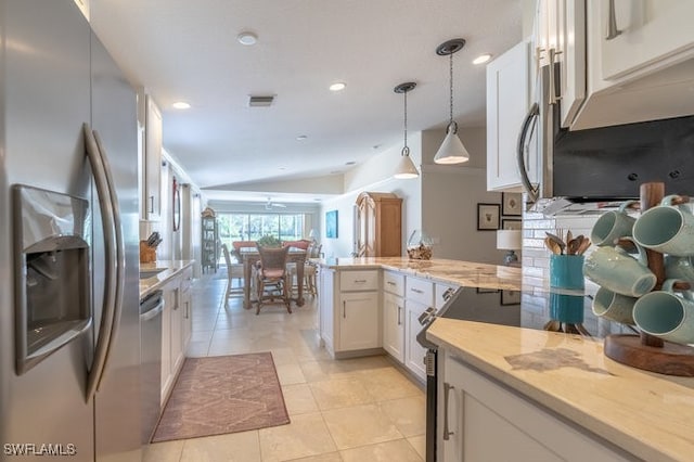 kitchen with kitchen peninsula, stainless steel appliances, pendant lighting, light tile patterned floors, and white cabinets