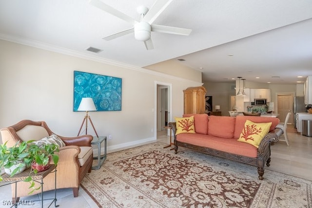 tiled living room featuring ceiling fan and ornamental molding