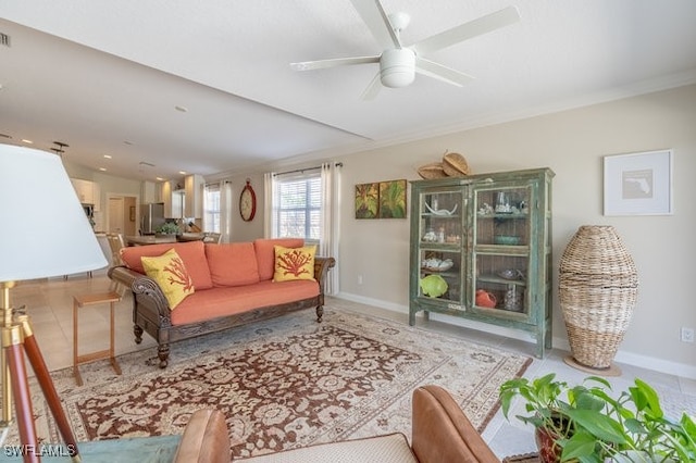 tiled living room featuring ceiling fan and crown molding