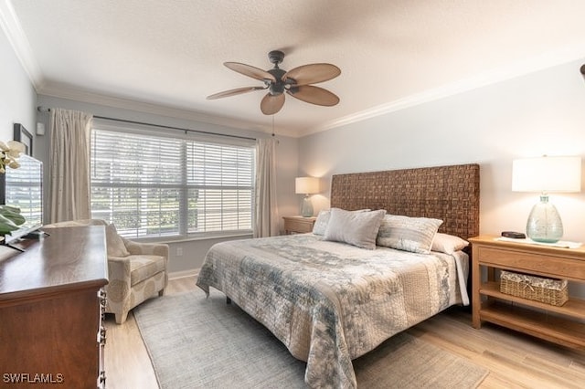 bedroom with light hardwood / wood-style floors, ceiling fan, and ornamental molding