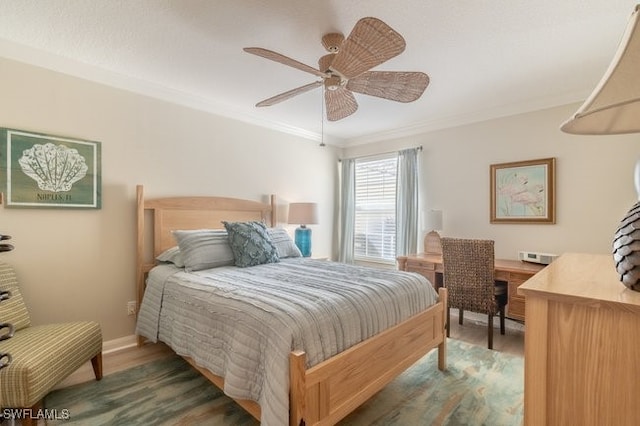 bedroom with ceiling fan, crown molding, and dark hardwood / wood-style floors