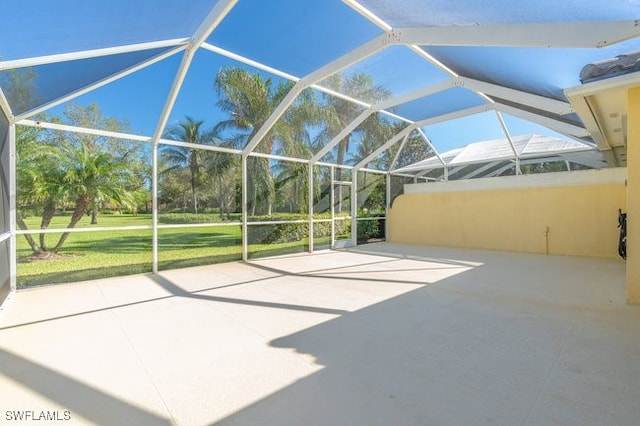 view of patio with glass enclosure