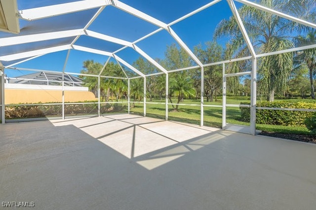 view of patio featuring glass enclosure