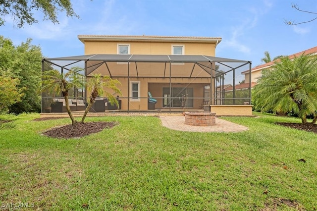 rear view of property featuring a lanai and a lawn