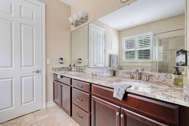 bathroom with tile patterned flooring, vanity, and walk in shower