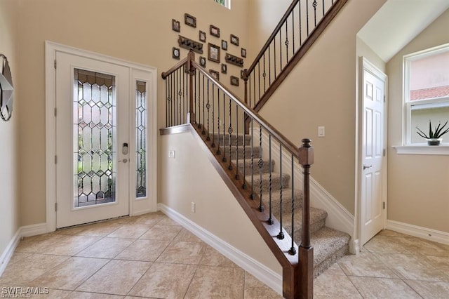 3290 Banyon Hollow Loop, North Fort Myers, FL 33903 - entryway with healthy amount of natural light, light tile patterned flooring, and stairs