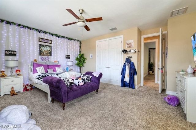 carpeted bedroom with ceiling fan and a closet