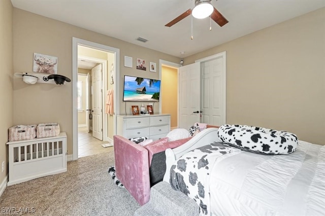 bedroom with ceiling fan and light colored carpet