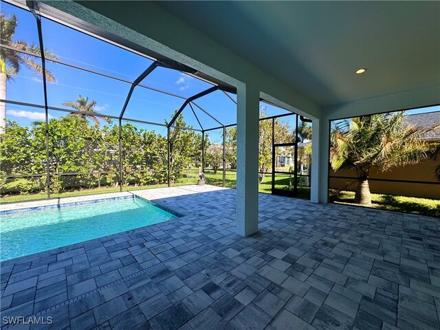 view of swimming pool with a lanai and a patio area