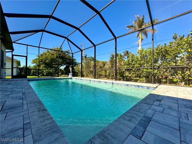 view of pool with a lanai and a patio area