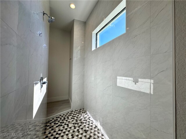 bathroom with a tile shower