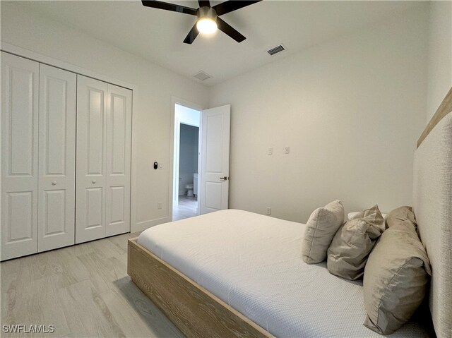 bedroom featuring ceiling fan, light wood-type flooring, and a closet