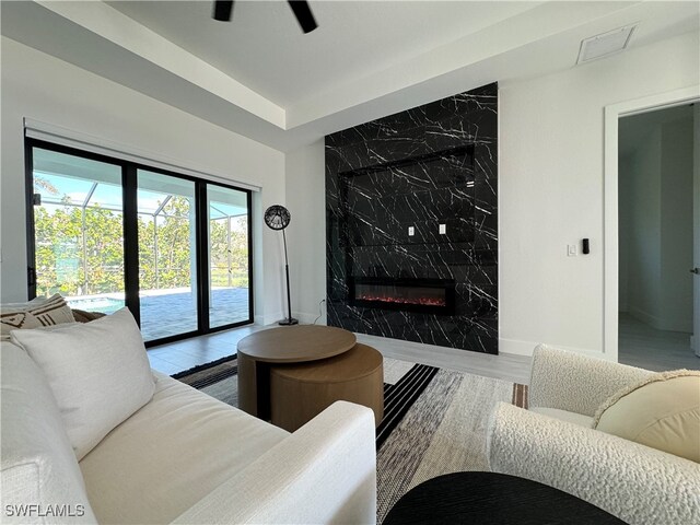 living room with hardwood / wood-style flooring and a premium fireplace