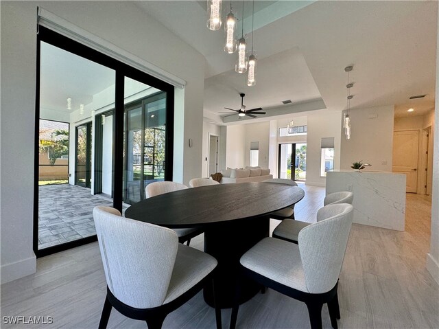 dining space featuring ceiling fan and light hardwood / wood-style flooring