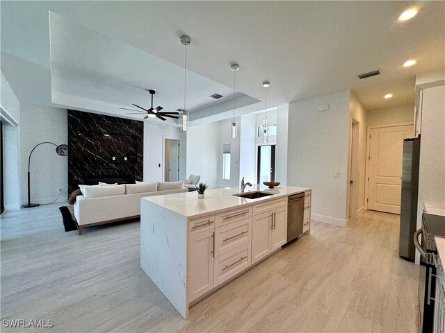 kitchen with stainless steel appliances, sink, pendant lighting, light hardwood / wood-style flooring, and white cabinets