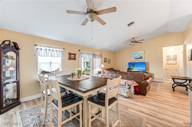 dining area featuring ceiling fan, light hardwood / wood-style flooring, and lofted ceiling