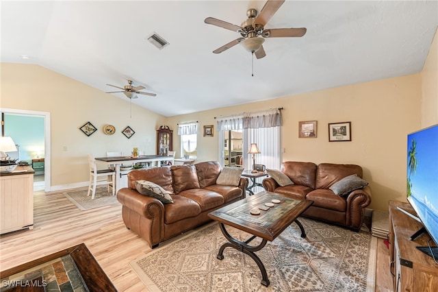 living room with ceiling fan, light wood-type flooring, and lofted ceiling