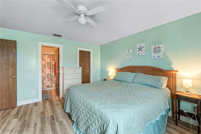 bedroom featuring ceiling fan, light wood-type flooring, and connected bathroom