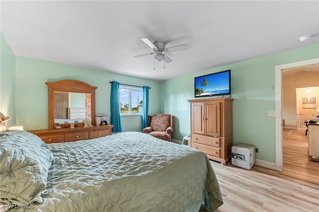 bedroom with ceiling fan and light hardwood / wood-style flooring