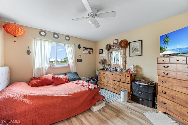 bedroom with ceiling fan and wood-type flooring